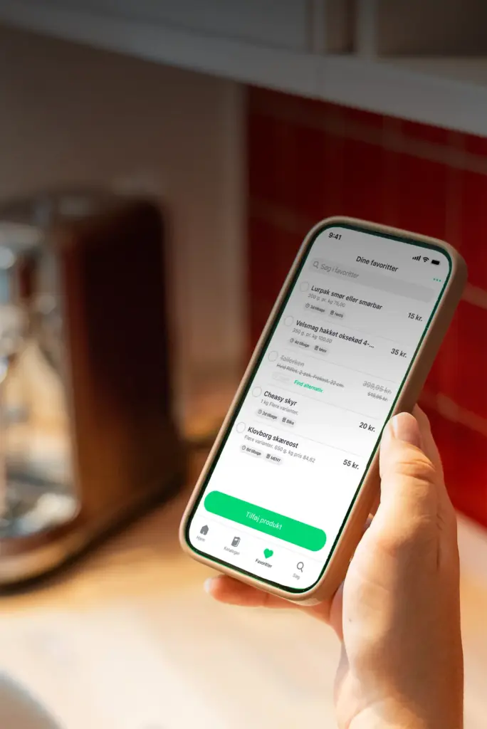 Bruger der holder mobil med MineTilbud-app og liste over favorittilbud